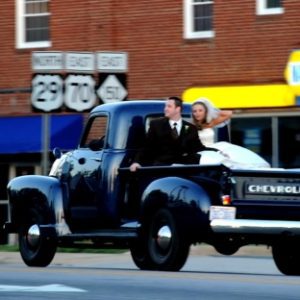 Newlyweds in back of pickup truck on a spring Saturday in Salisbury.