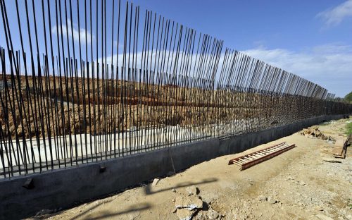   On Cullman Avenue, between Little Sugar Creek and light rail, rebar set in place for a retaining wall. Photo: Nancy Pierce 6-11-15  Rebar has been set in place for a cast-in-place retaining wall, which will be part of the art wall, “Trap plant, sundew and leaves,” from artist Carolyn Braaksma. This scene is along Cullman Avenue in NoDa, between Little Sugar Creek and the rail line. Photo: Nancy Pierce