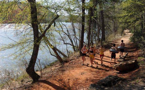 A group of runners passes two boys on the Broad River Greenway in April 2010.