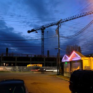 Neon lights from the decades-old South Boulevard adult entertainment venue, Leather and Lace, illuminate the parking lot of beloved burger and ice cream shop, Mr K.s, which dates to 1967. In the background, a short walk from the East-West Boulevard Station, Crescent Communities' Novel Atherton "luxury apartment homes" is set to open in 2019. Photo: Nancy Pierce  