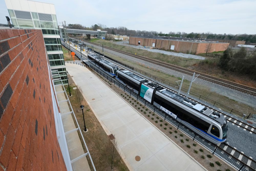 Industrial buildings and warehouses surround the newly built Sugar Creek Road station. It contains one of three new parking decks along the Blue Line Extension, and offers free parking. Photo: Nancy Pierce. 