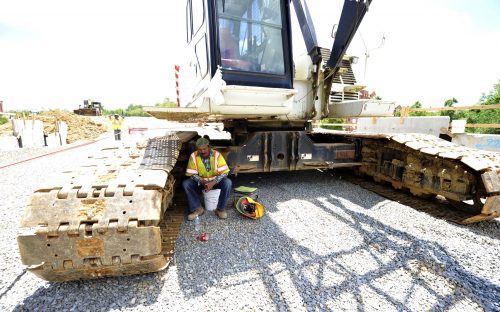  Crane operator near Toby Creek at UNCC light rail construction. Photo: Nancy Pierce 6-11-15 At noon on a 95-degree day, a crane operator near Toby Creek on the UNC Charlotte campus takes a lunch break in the small spot of shade cast by the rig. Photo: Nancy Pierce