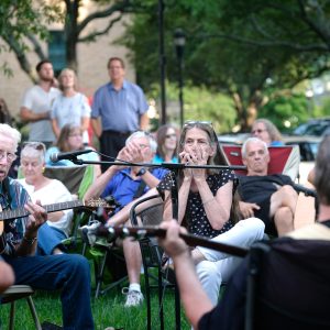 Musicians at the Bluegrass & Old-Time Jam Session on the square in Shelby, playing in front of the Earl Scruggs Center. Photo: Nancy Pierce.