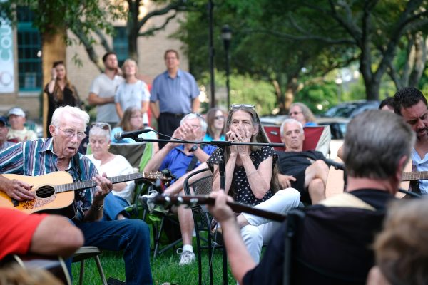 Musicians at the Bluegrass & Old-Time Jam Session on the square in Shelby, playing in front of the Earl Scruggs Center. Photo: Nancy Pierce.