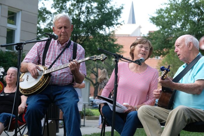 Musicians at the Bluegrass & Old-Time Jam Session on the square in Shelby, playing in front of the Earl Scruggs Center. Photo: Nancy Pierce.