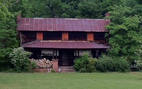 Ivy growing on native stone chimney of Vanhoy House in Uwharrie community; typical I-house style.