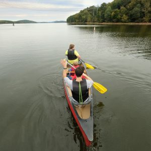 The 10 Days of Uwharrie outdoor festival in October 2019 included canoe rides on Badin Lake. Overhead power lines are from Badin's hydroelectric dam. Photo: Nancy Pierce.