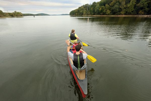 The 10 Days of Uwharrie outdoor festival in October 2019 included canoe rides on Badin Lake. Overhead power lines are from Badin's hydroelectric dam. Photo: Nancy Pierce.